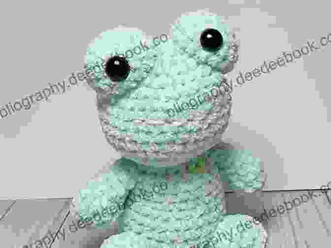 A Cheerful Crocheted Frog Made With Chunky Yarn, Featuring Bulging Eyes, A Wide Smile, And Webbed Feet. Mabel Bunny Co : 15 Loveable Animals To Crochet Using Chunky Yarn