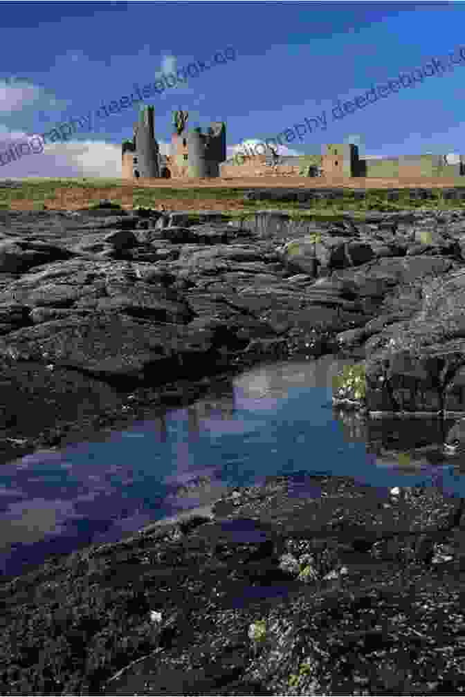 Dunstanburgh Castle's Imposing Ruins Dominate A Rugged Headland Against The Dramatic Backdrop Of The North Sea Follies Of Northumberland (Follies Of England 27)